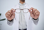 Hands, person and optometrist with glasses for vision, eyesight and prescription eye care. Closeup of doctor, optician and frame of lens, eyewear test and consulting for optical healthcare assessment