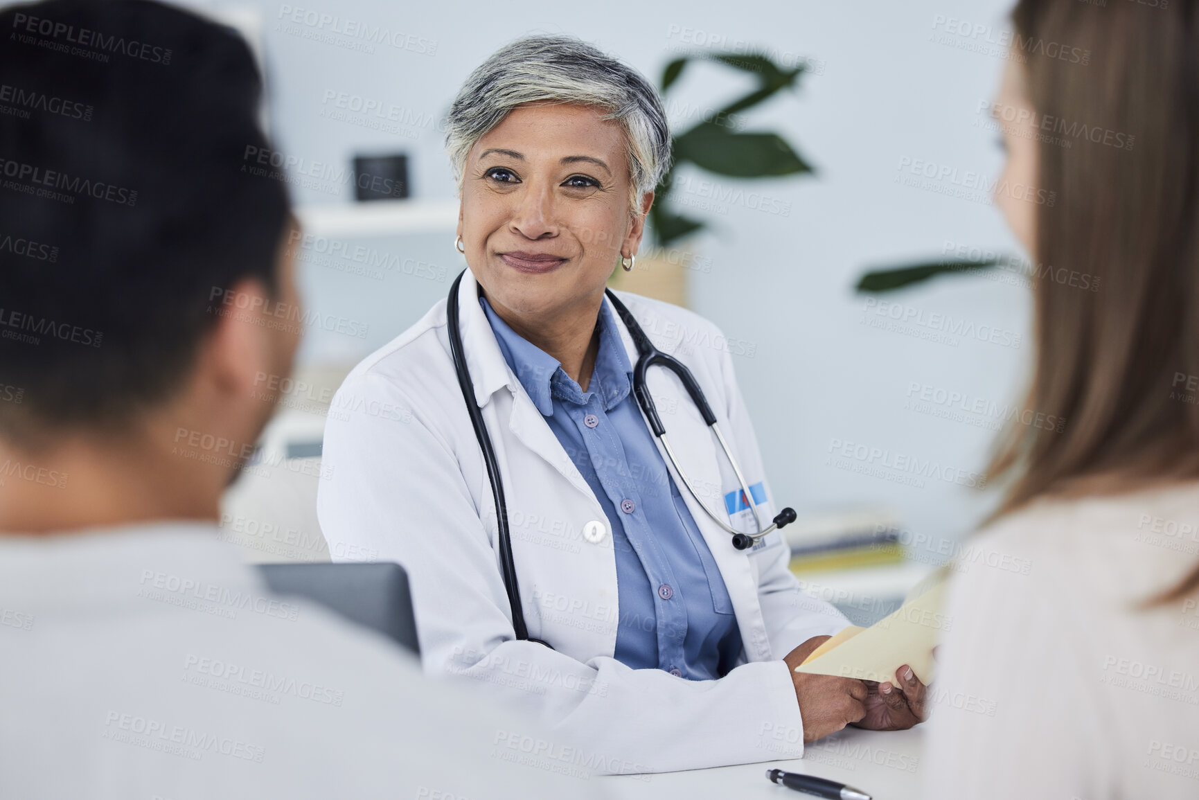 Buy stock photo Senior woman, doctor and couple in consultation for healthcare advice or life insurance at hospital. Happy mature female person or medical professional in meeting, discussion or consulting patients