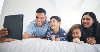 Buy stock photo Digital tablet, video call and happy family in bed relax, smile and bond with online communication. Bedroom, selfie and children with parents for profile picture or photo in their home on the weekend