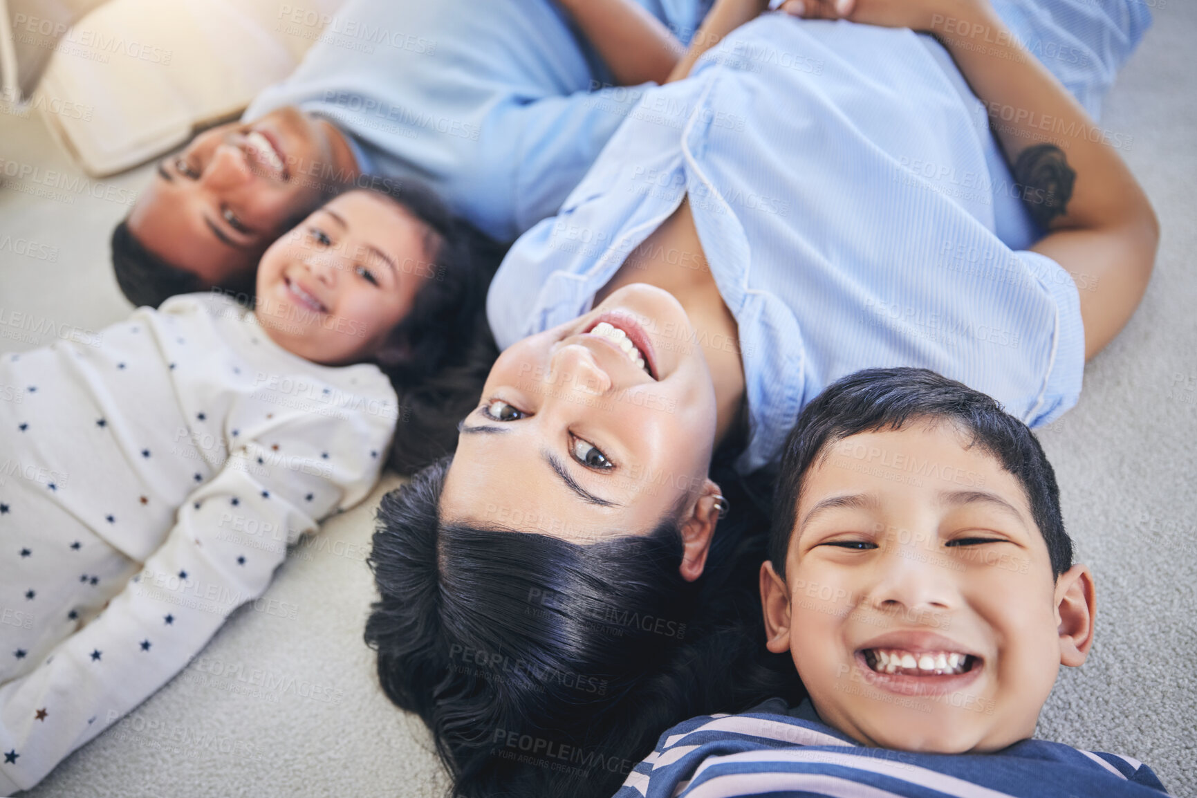 Buy stock photo Top view, portrait and happy family on a floor relax, bond and playing in their home on the weekend. Face, smile and above children with young parents in a bedroom with love, fun and chilling
