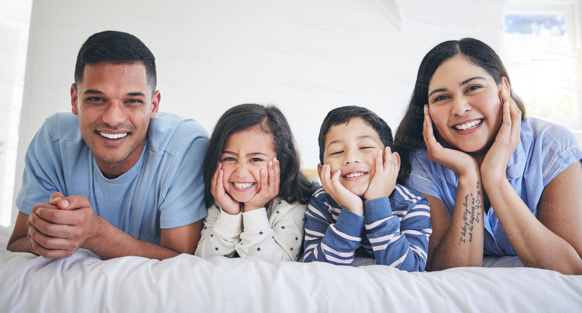 Buy stock photo Happy family, portrait and kids with parents on a bed relax, excited and bonding in their home. Face, smile and children with mother and father in bedroom for weekend, chilling and waking up playful