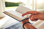 Reading book, muslim or hands of person with Quran on Eid Mubarak praying to God or worship at home. Allah, hope or Ramadan with spiritual man learning Islamic info for faith, religion and gratitude