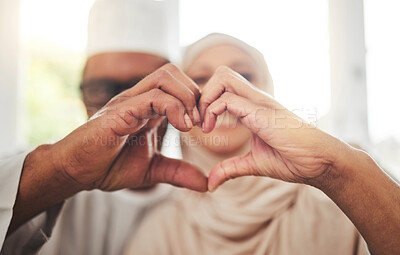 Buy stock photo Love, Muslim or senior couple with heart hands for support, trust and care in retirement, bonding or marriage. Emoji icon, Islamic home or Arab man, woman and elderly people together for quality time