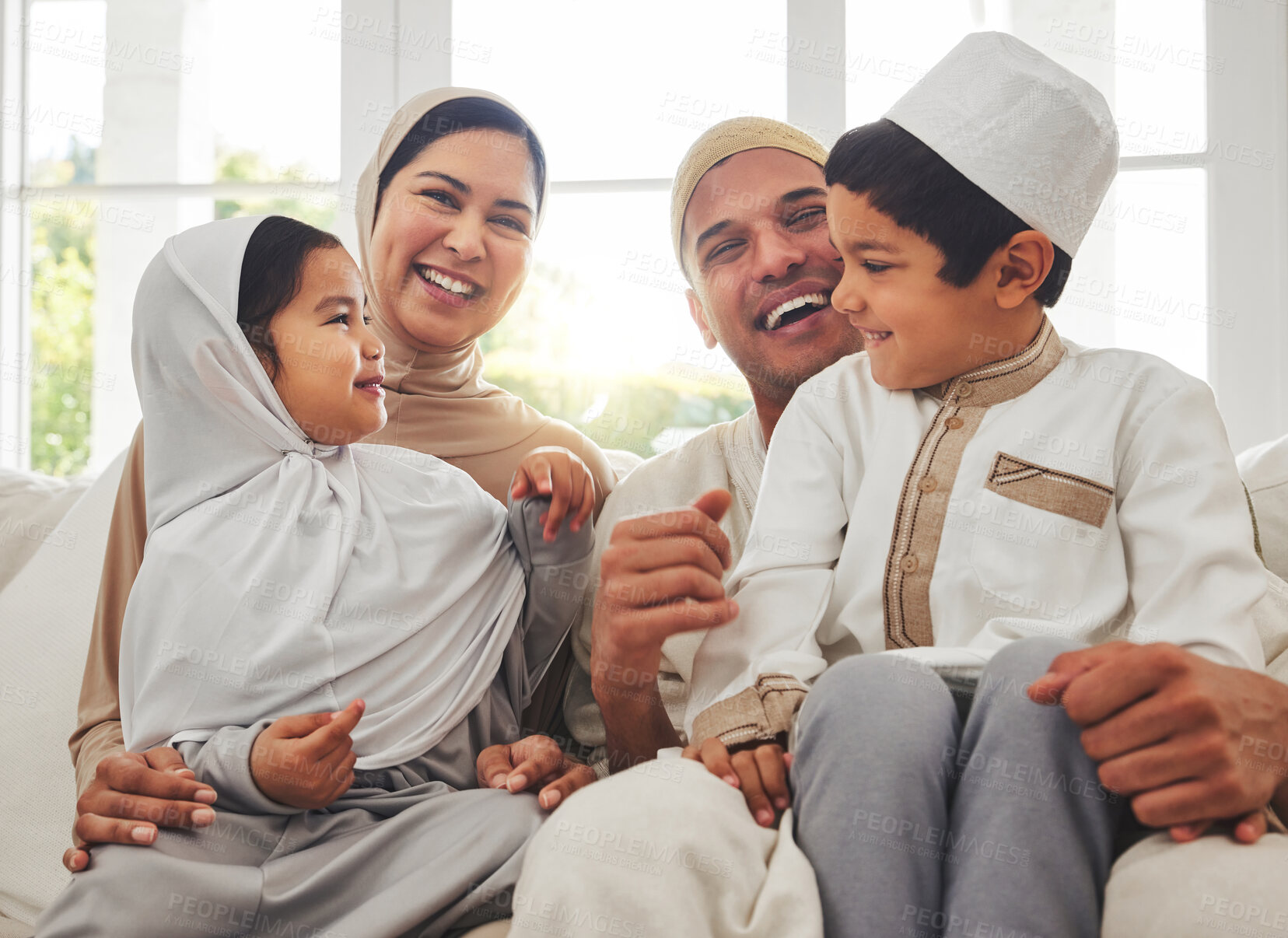 Buy stock photo Happy family, Islam and laughing on couch for Eid with mom, dad and kids with home culture in Indonesia. Muslim man, woman in hijab and children smile, funny bonding on sofa together in living room.