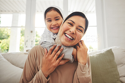 Buy stock photo Portrait, hug and muslim mother, happy child or family bonding, laugh and enjoy quality time together. Living room sofa, happiness and face of Islamic mom, youth kid or Arabic people embrace at home