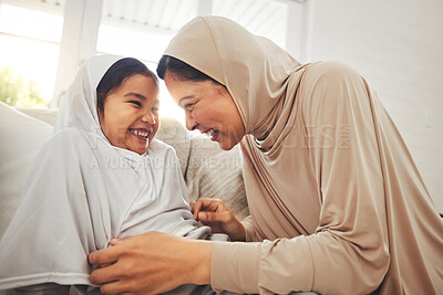 Buy stock photo Laughing, play and muslim grandmother, happy child or family bond, enjoy quality time together and granny tickle girl. Lounge sofa, funny or Islamic grandma, youth kid or playing people laugh at home