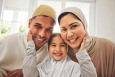 Buy stock photo Islam, portrait and smile, parents and kid in living room for Eid with mom, dad and daughter with home culture. Face of Muslim man, woman in hijab and child in Ramadan on sofa together in Indonesia.