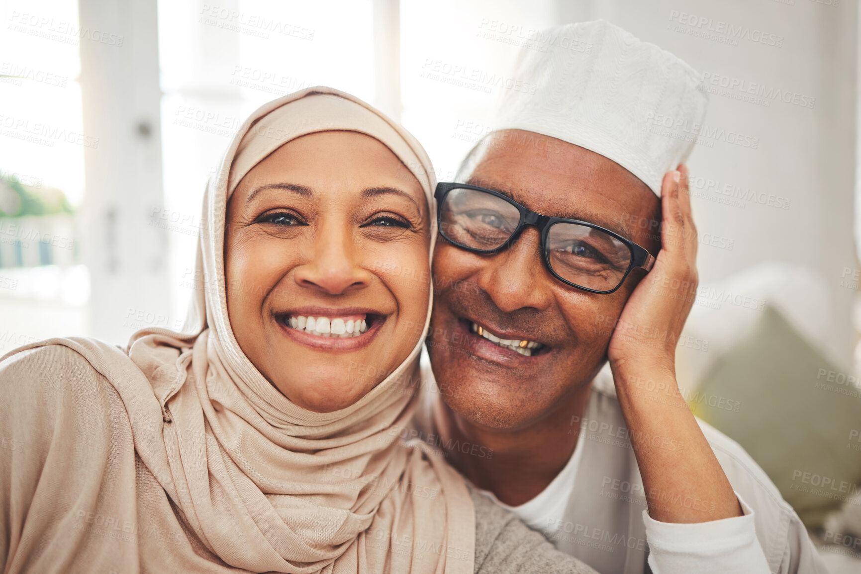 Buy stock photo Portrait, Islam and senior couple in living room for Eid with smile, culture and love in home in Morocco. Face of elderly Muslim man, happy woman in hijab and happiness in marriage on sofa together.