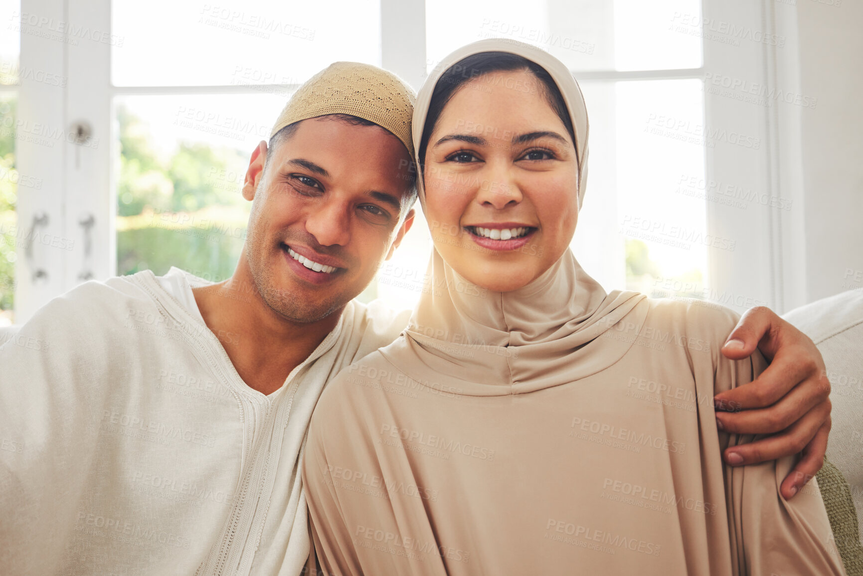 Buy stock photo Portrait, Islam and happy couple on couch for Eid with smile, culture and love in home in Dubai. Face of Muslim man, woman in hijab and happiness in marriage on sofa, together in respect and religion