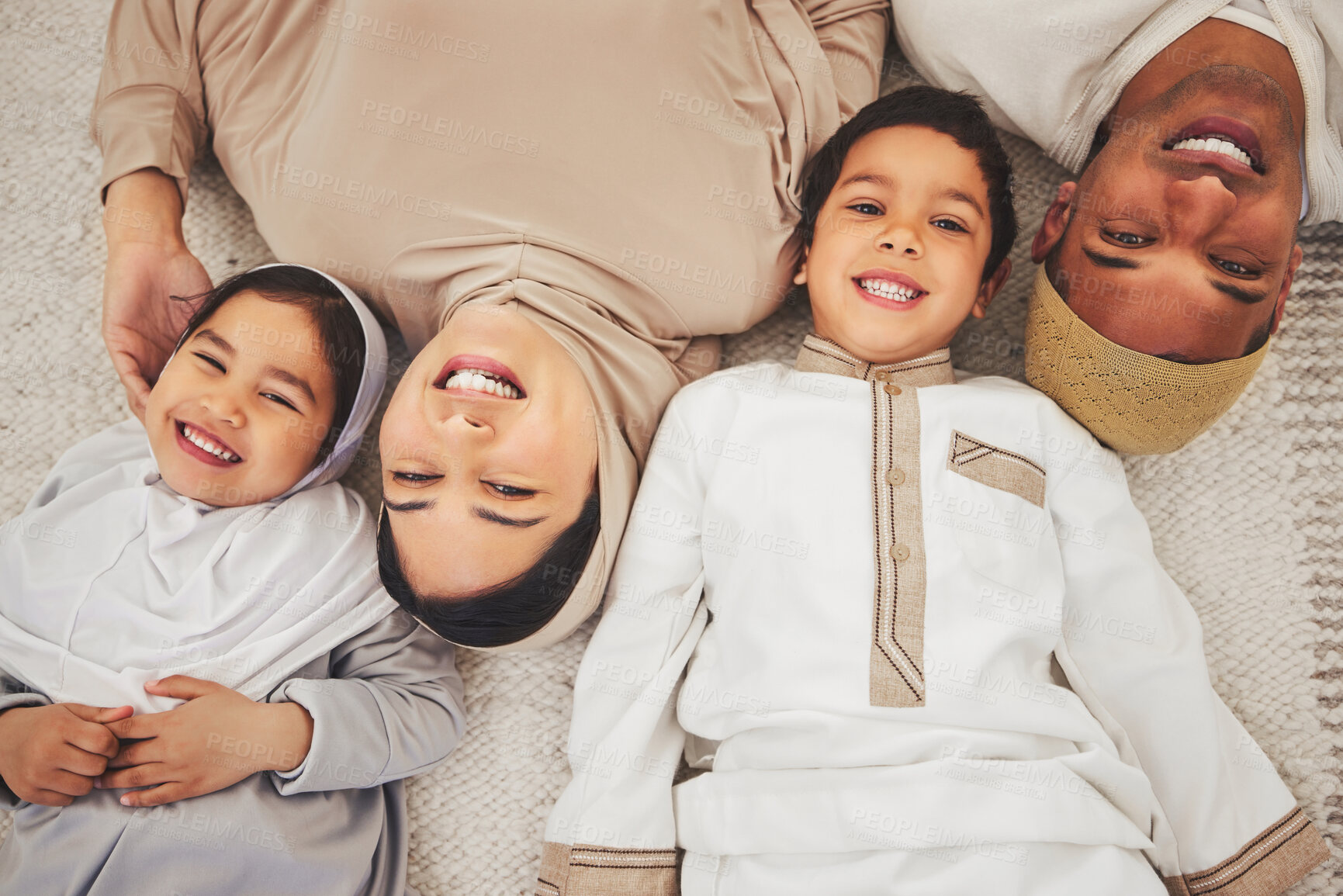 Buy stock photo Portrait smile, floor and muslim family of mother, father and children smile, love or enjoy quality time together. Lounge top view, care and happy face of Islamic mom, young kids or dad relax at home