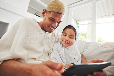 Buy stock photo Family, tablet or education with a father and muslim girl on a sofa in the living room of their home together for e learning. Kids, study or child development with a man teaching his student daughter