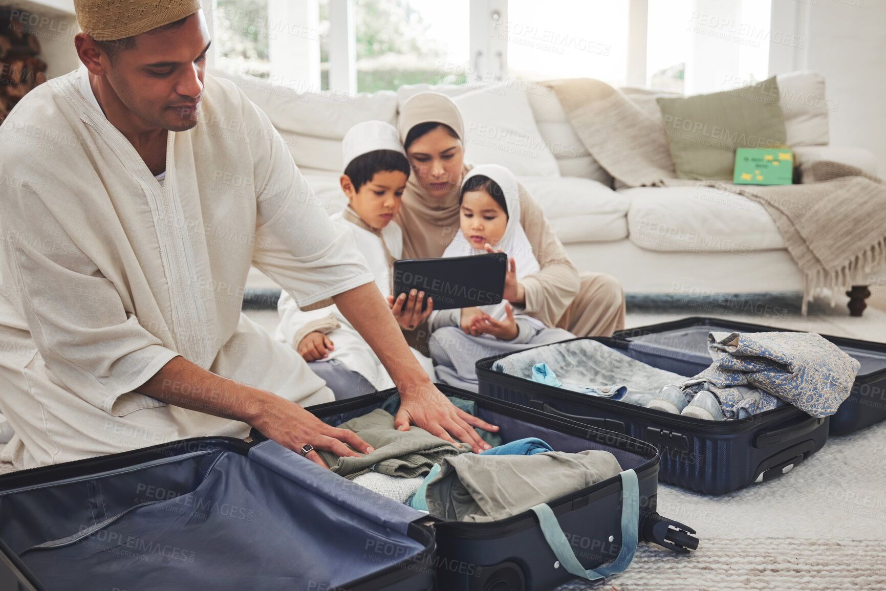 Buy stock photo Travel, packing and Muslim family with suitcase in living room for holiday, vacation and religious trip. Home, luggage and parents and children with tablet and bag for journey, adventure and tourism