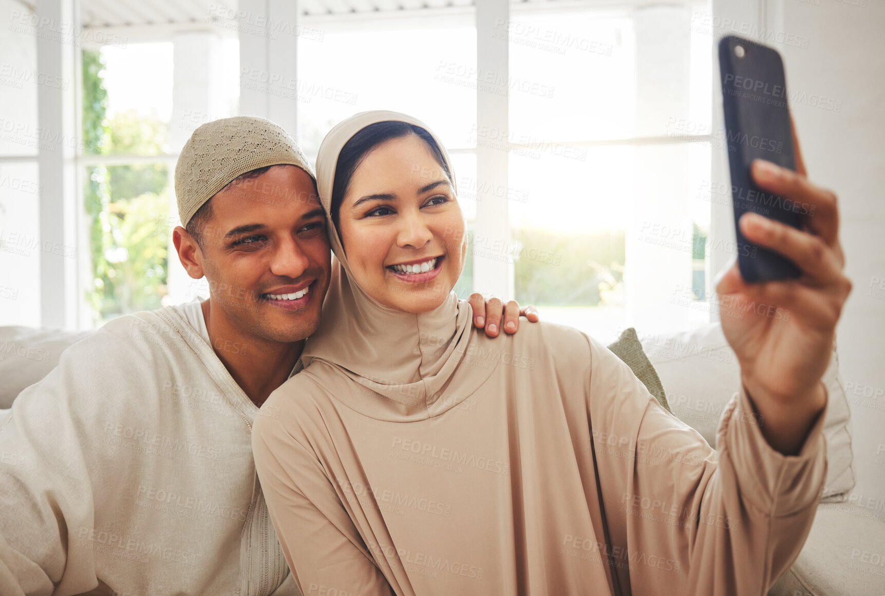 Buy stock photo Selfie, Islam and happy couple on couch with smile, culture and love in living room in Indonesia. Marriage, man and woman in hijab on sofa together with respect, religion and photo for social media.