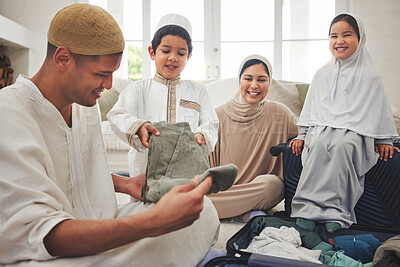 Buy stock photo Eid, packing and a Muslim family in a house for a holiday, or vacation preparation together. Happy, talking and Islamic parents with young children and a suitcase for clothes, travel  or hajj