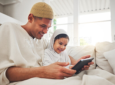 Buy stock photo Family, tablet or study with a father and muslim girl on a sofa in the living room of their home together for e learning. Kids, education or child development with a man teaching his student daughter