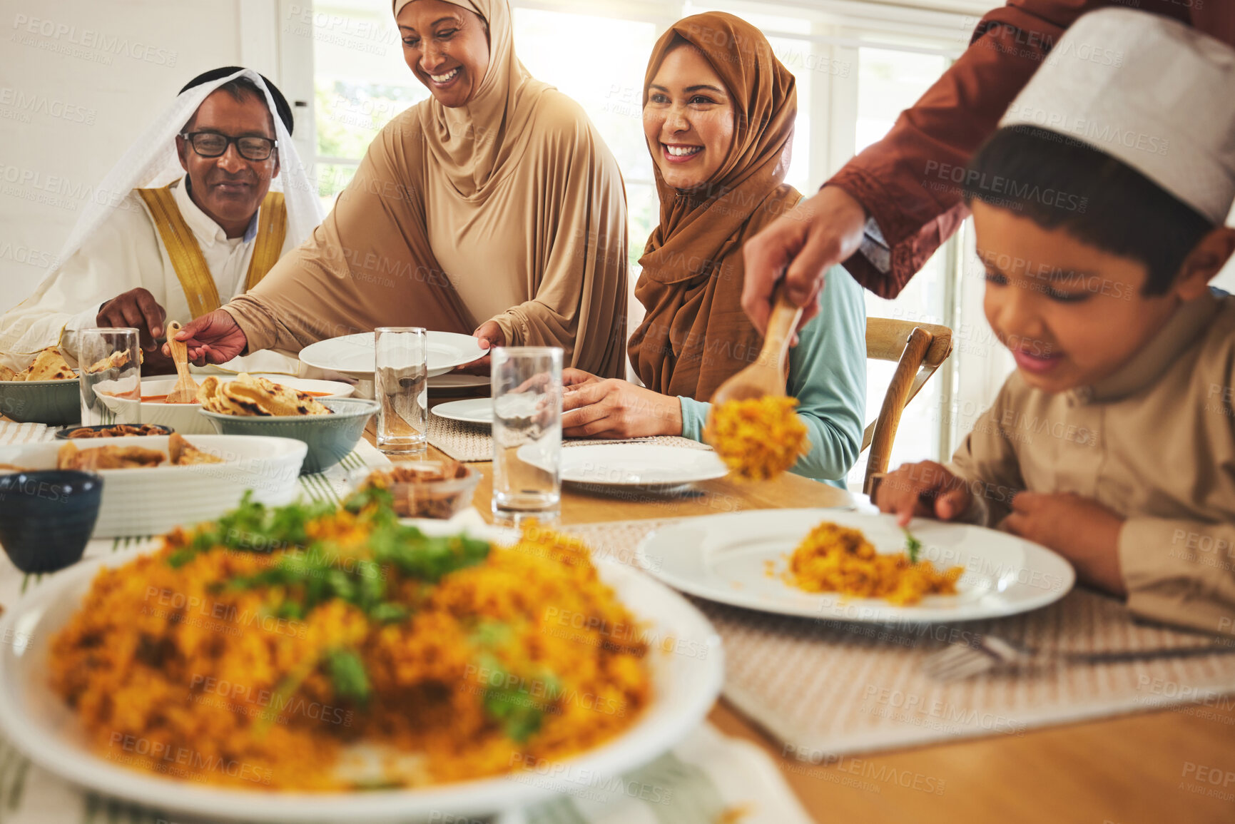Buy stock photo Food, islam and muslim with big family at table for eid mubarak, Islamic celebration and lunch. Ramadan festival, culture and iftar with people eating at home for fasting, happy and religion holiday