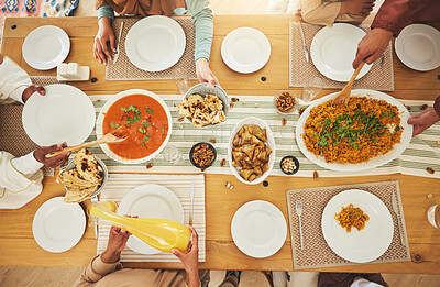 Buy stock photo Food, Eid Mubarak and above of family eating at table for Islamic celebration, festival and lunch together. Ramadan, religion and hands with meal, dish and cuisine for fasting, holiday and culture