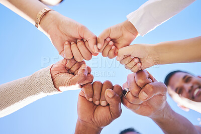 Buy stock photo Big family, fist bump and teamwork synergy in circle for support, trust or unity in collaboration outdoors. Low angle of people or friends touching hands for team building, community or goals outside