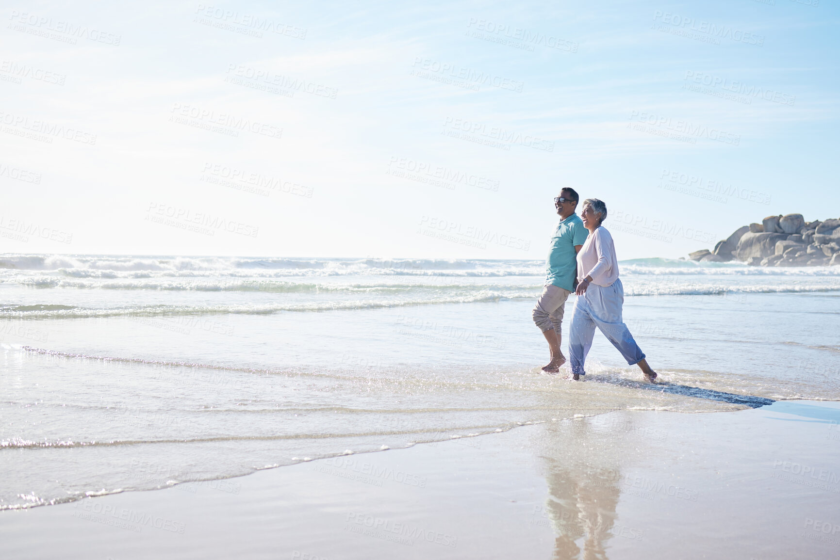 Buy stock photo Beach, walking and senior couple holding hands for bonding, quality time and relax in nature. Love, retirement and happy elderly man and woman by ocean on holiday, vacation and travel in morning