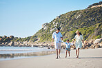 Beach, mother and father holding hands with a child for fun, family adventure and play on holiday. A happy woman, man and young kid walking on sand for vacation at ocean, nature or outdoor in summer
