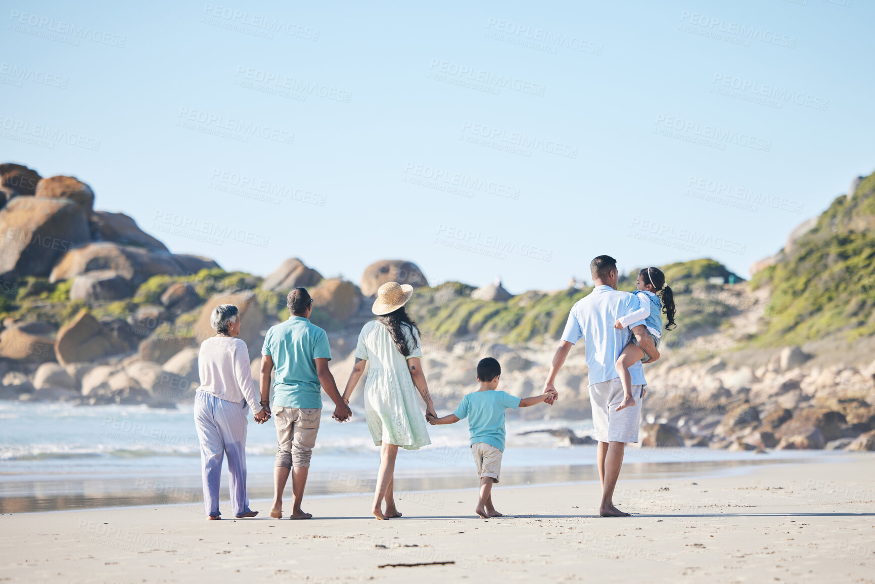 Buy stock photo Beach, walking and grandparents, parents and children by sea for bonding, quality time and relax in nature. Family, travel and back of mom, dad and kids by ocean on holiday, vacation and adventure