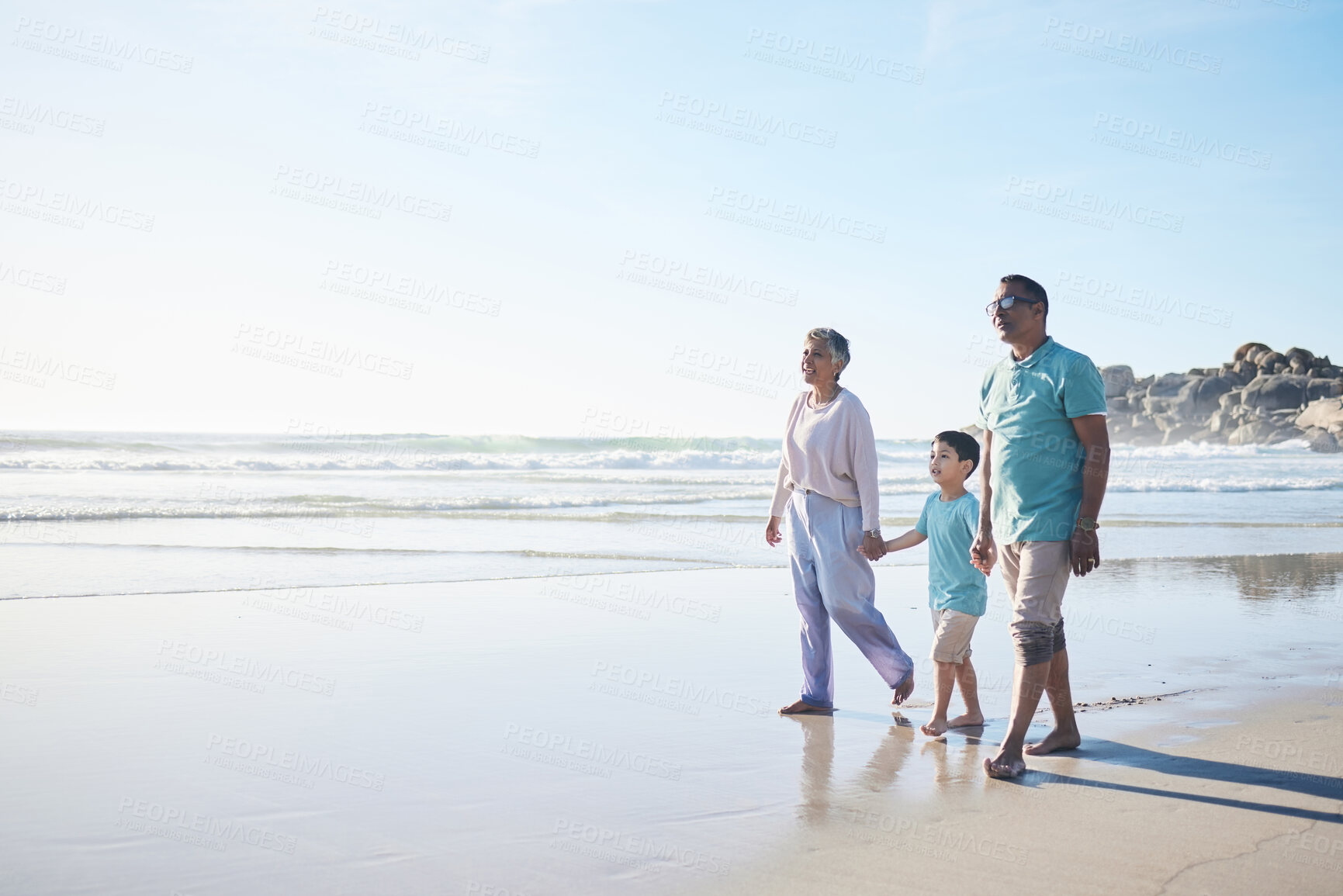 Buy stock photo Beach, walking and senior couple with boy for bonding, quality time and relaxing in nature. Family, travel and happy elderly man and woman with child by ocean on holiday, vacation and adventure