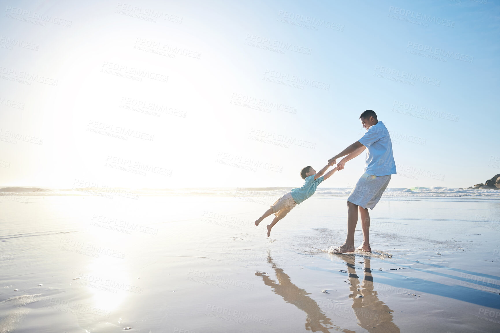 Buy stock photo Family, father and spinning a child at the beach for fun, adventure and play on holiday. A man and young kid holding hands on vacation at the ocean, nature or outdoor with mockup banner space in sky