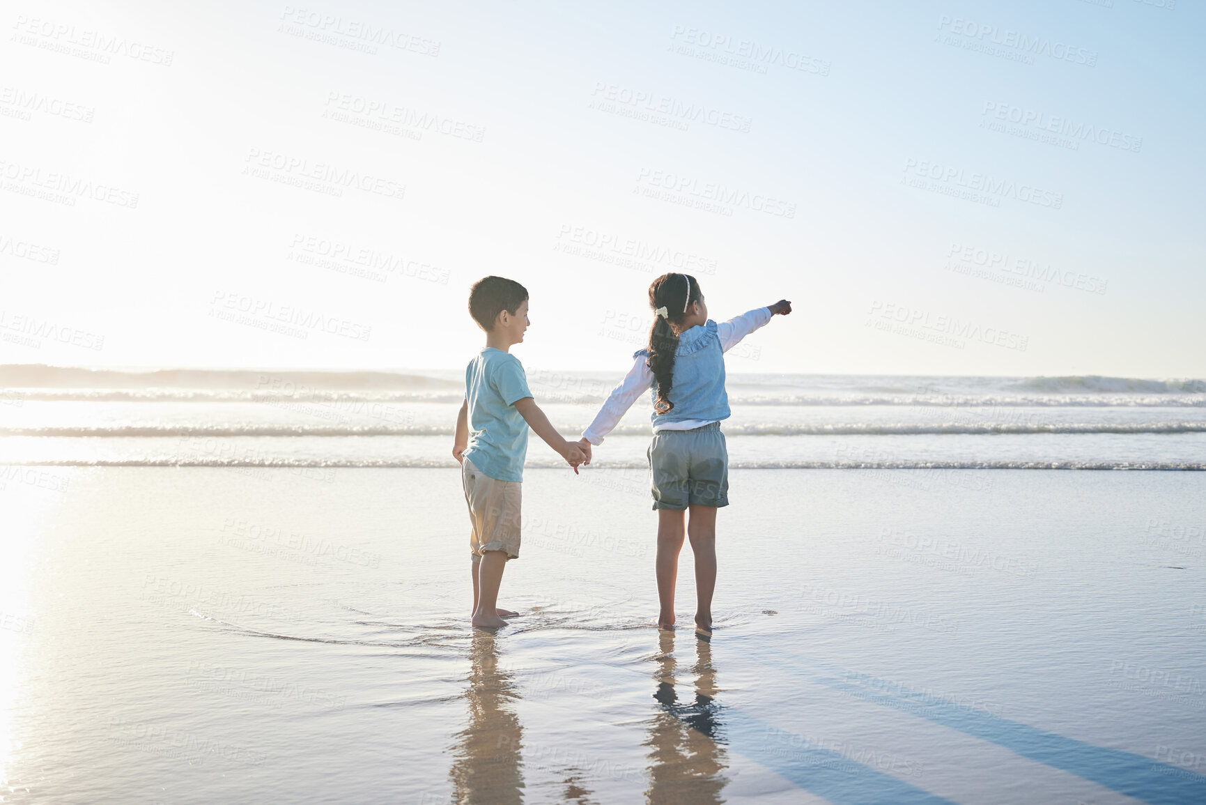 Buy stock photo Beach, travel and back of children holding hands while on a vacation, holiday or adventure. Freedom, love and kid siblings playing and bonding together by the ocean on a tropical summer weekend trip.