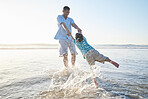 Beach, family and father and swinging a child for fun, adventure and play on holiday. A man and young kid holding hands on vacation at the ocean, nature or outdoor with water splash and freedom