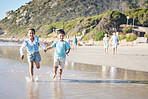 Kids, brother and sister running at beach, excited and holding hands with smile, adventure and vacation. Young children, happy and playful with race, games and freedom by ocean for summer in Hawaii