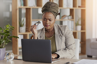 Buy stock photo Focus, serious and businesswoman working on a laptop in the office reading data for a project. Technology, planning and young African female lawyer doing research on a computer in the workplace.