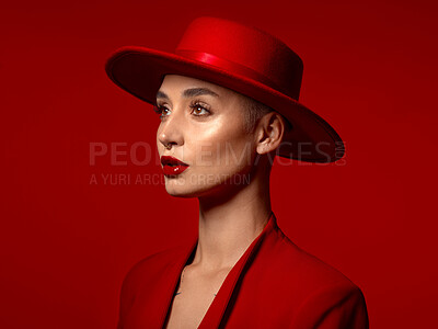 Buy stock photo Vision, fashion and a model woman on a red studio background for elegant or trendy style. Aesthetic, art and hat with a young female person looking edgy or classy in a suit or unique clothes