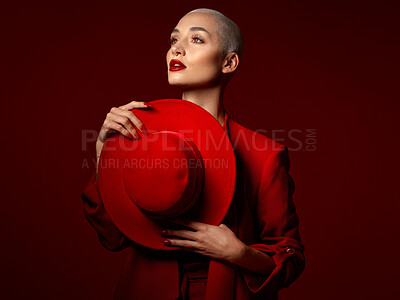 Buy stock photo Thinking, fashion and hat with a woman on a red studio background for elegant or trendy style. Vision, art and beauty with a young female model looking edgy or classy in a suit or unique clothes