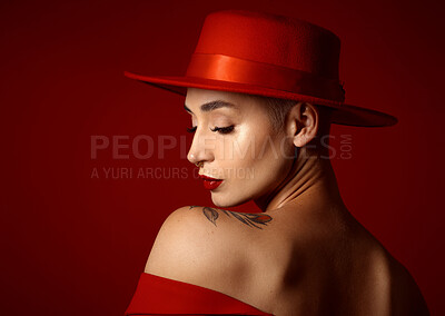 Buy stock photo Back, fashion and a model woman on a red studio background for elegant or trendy style. Aesthetic, face and beauty with a young female person in an edgy, classy or unique outfit for a magazine cover