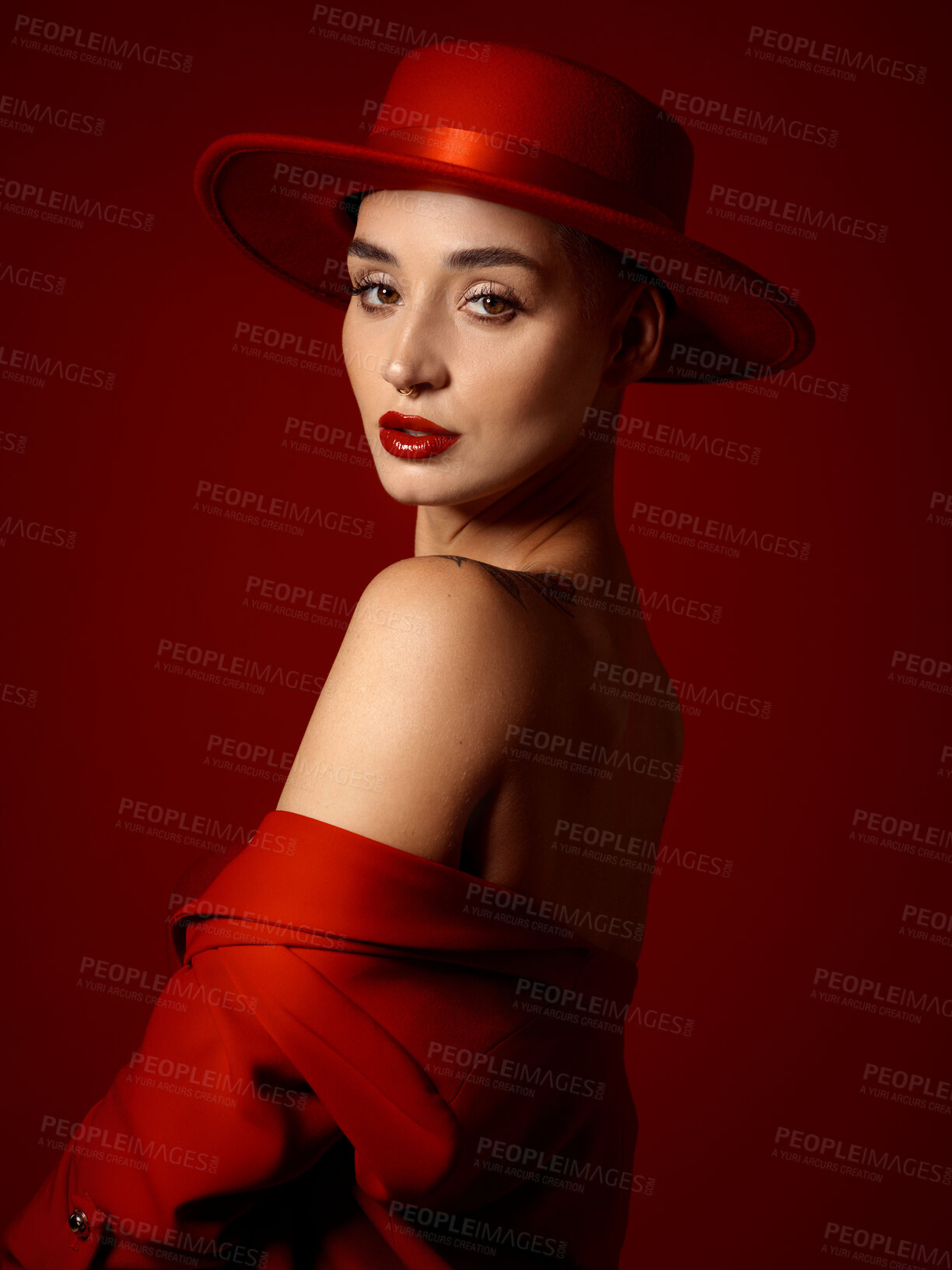 Buy stock photo Portrait, fashion and a woman runway model on a red studio background for elegant or trendy style. Aesthetic, art and beauty with a young female person looking over her shoulder in a classy outfit
