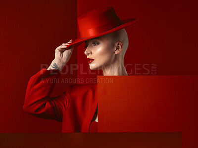 Buy stock photo Fashion, woman and red hat with cosmetic or luxury in studio red background with creative retro suit. Style, runway and girl with makeup with vintage clothes with confident, unique and edgy model.