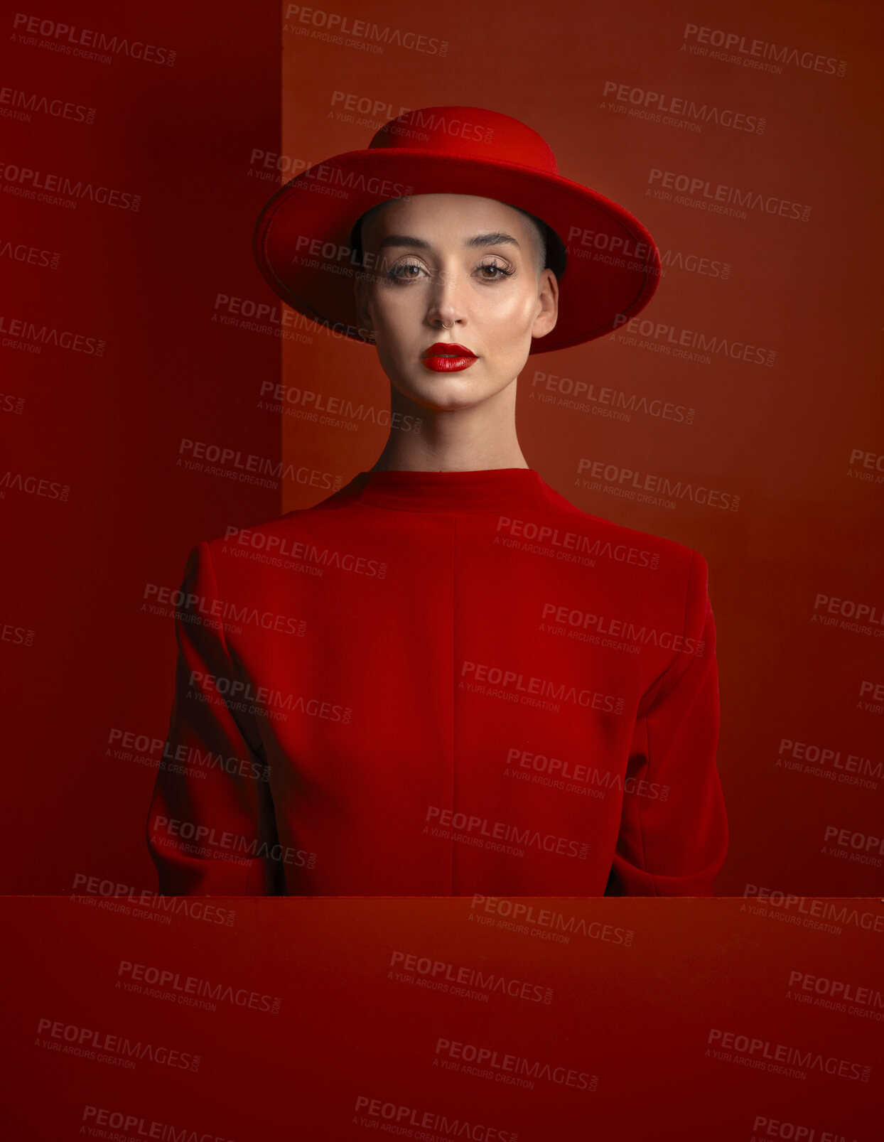 Buy stock photo Portrait, reverse fashion and mockup with a woman on a red background in studio for marketing, advertising or branding. Luxury, aesthetic style or trendy young female model standing with empty space