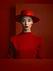 Portrait, fashion and space with a woman in red on a studio background for marketing, advertising or branding. Reverse, style or a trendy young female person standing with empty or blank mockup