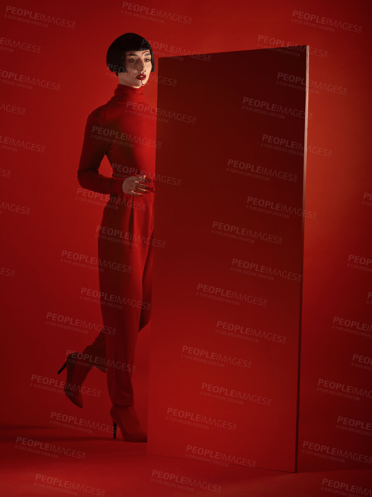 Buy stock photo Fashion, mockup and a model woman in a red background in studio for marketing, advertising or branding. Luxury, aesthetic style or a trendy young female person standing with an empty or blank poster