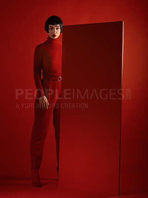 Buy stock photo Fashion, art and portrait of woman with red board, futuristic makeup and unique studio background. Future aesthetic, cyberpunk and creative beauty, body of model in dark luxury designer brand mockup.