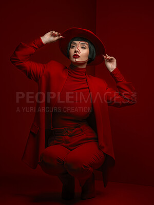 Buy stock photo Woman, fashion and beauty with red aesthetic, makeup with art deco and vintage hat isolated on studio background. Retro style, female model with serious expression and cosmetics, attractive and bold