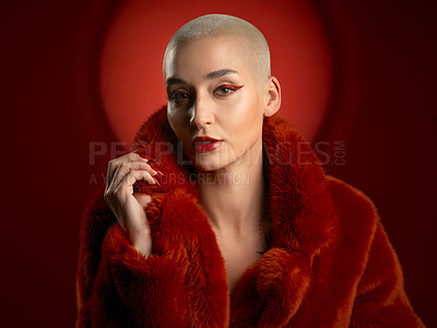 Buy stock photo Fashion, portrait and confident woman in a red coat in studio isolated on a background. Face, makeup and serious model with cosmetics, aesthetic and style, trendy and fur clothes from Switzerland.