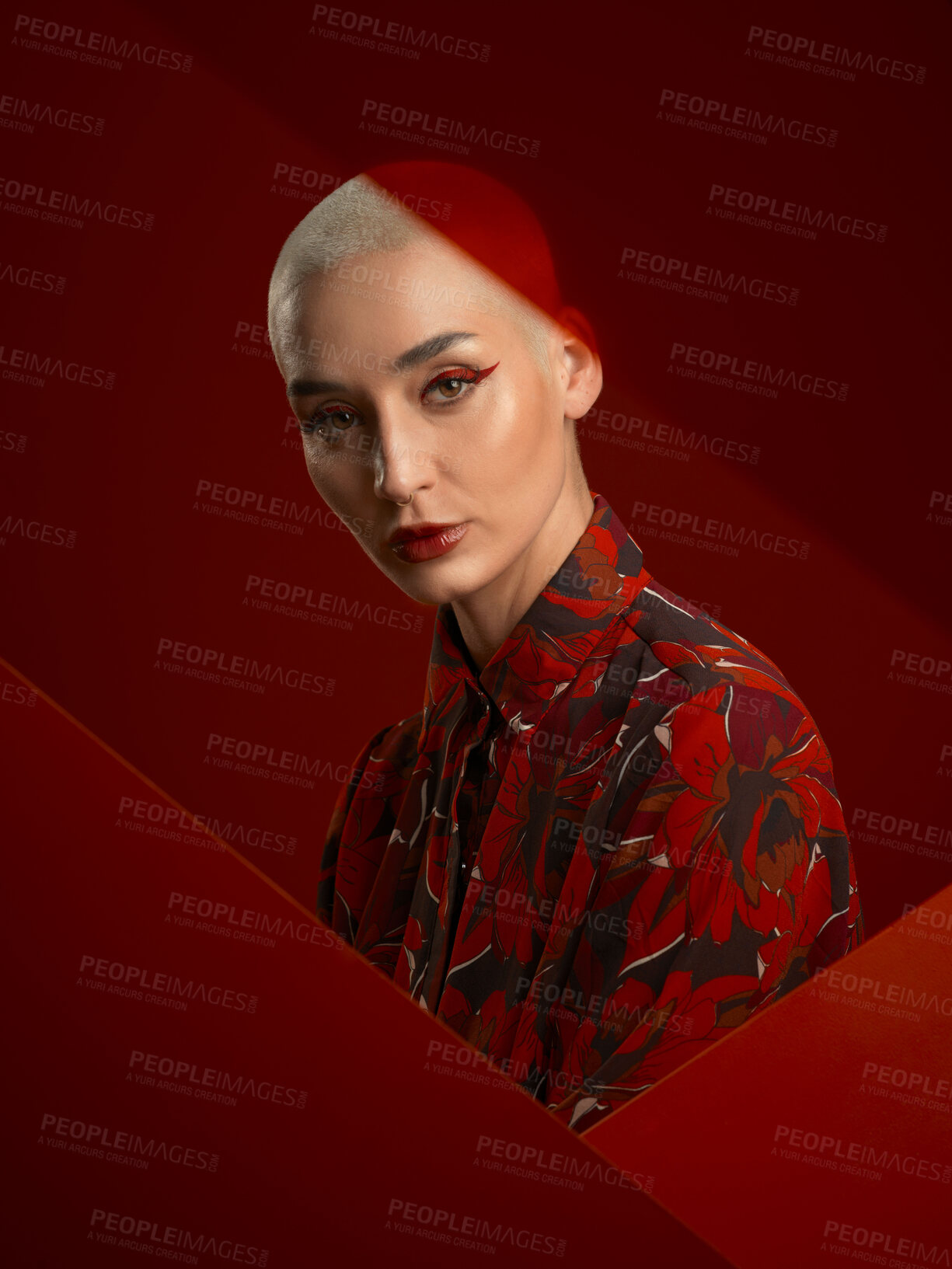 Buy stock photo Woman, fashion and portrait with red aesthetic, beauty and makeup with floral shirt isolated on studio background. Skin glow, female model with serious expression and cosmetics, attractive and bold