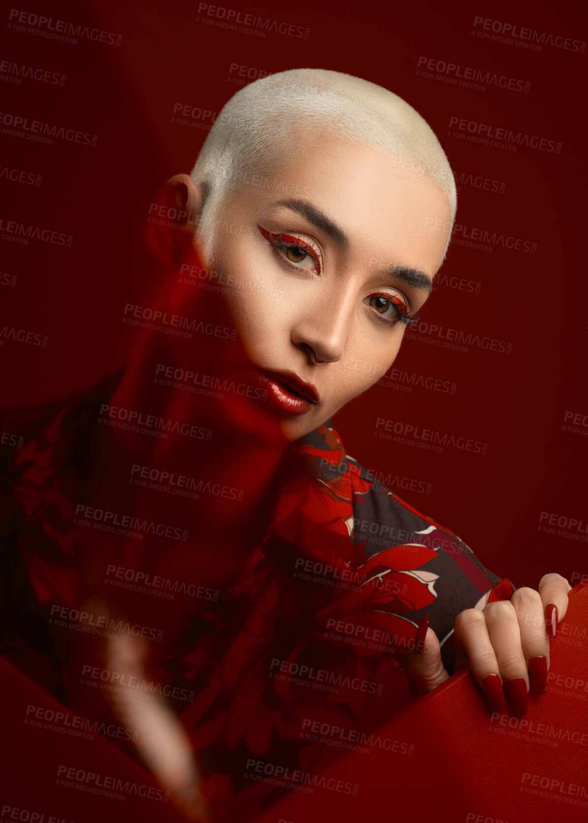 Buy stock photo Face, fashion and serious woman with makeup in studio isolated on a red background. Portrait, confident or female model with cosmetics, aesthetic or stylish, trendy or classy clothes from Switzerland