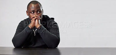 Buy stock photo Stress, fear and criminal in handcuffs for prison or interrogation on mockup space banner for crime, fraud or arrest in justice. Black man, gangster prisoner and thief in jail for question or robbery