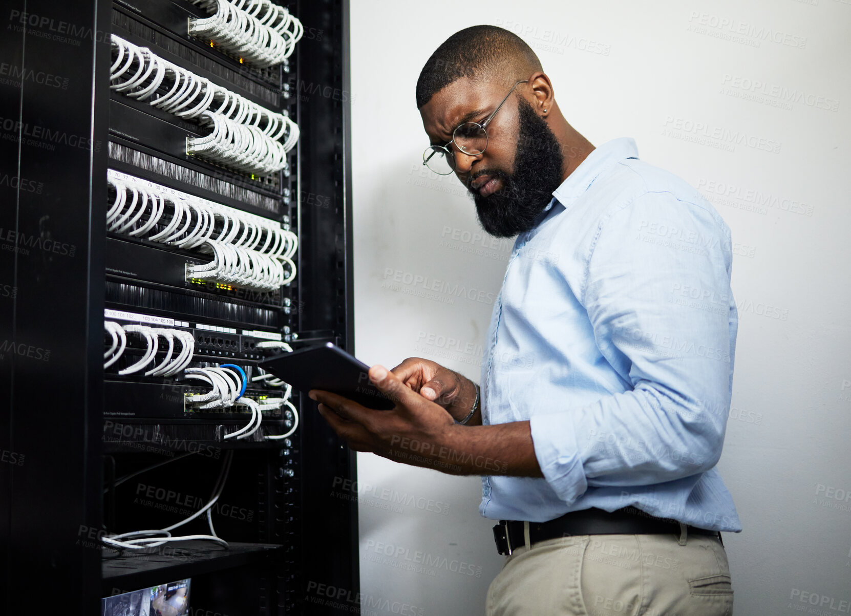 Buy stock photo Data center, tablet and serious technician man with cables for internet connection for software programming. Engineer black person with tech for cybersecurity, wire or problem solving in server room