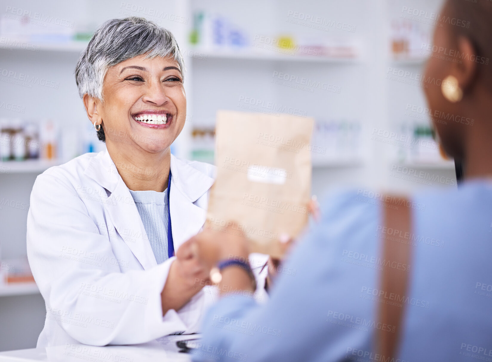 Buy stock photo Happy woman, pharmacist and medication for patient prescription over the counter at the pharmacy. Female person, medical or healthcare professional giving customer pills or pharmaceutical package