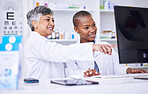 Senior woman, pharmacist and coaching intern on computer for data, inventory or stock at pharmacy. Happy mature female person, coach or employee training staff on PC in healthcare services at clinic