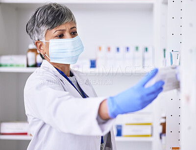 Buy stock photo Pharmacy, medicine and woman in face mask for healthcare, medical inventory and pharmaceutical service. Shelf, product and reading label of pharmacist or senior person for virus, bacteria or covid 19