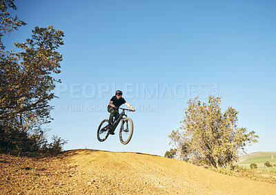 Buy stock photo Downhill, mountain bike and man outdoor in nature for extreme sports, training or workout. Hill, countryside and male person with courage or bicycle stunt for off road cycling, travel or adventure
